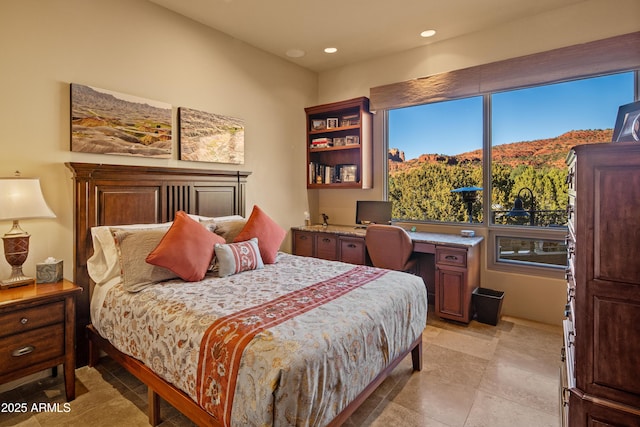 bedroom with built in desk and recessed lighting