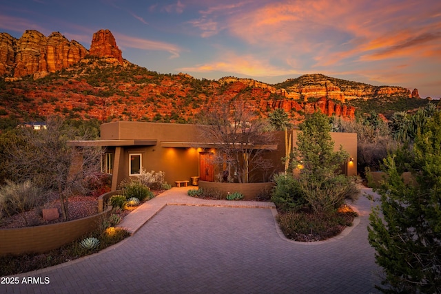 view of front of house with a mountain view and stucco siding