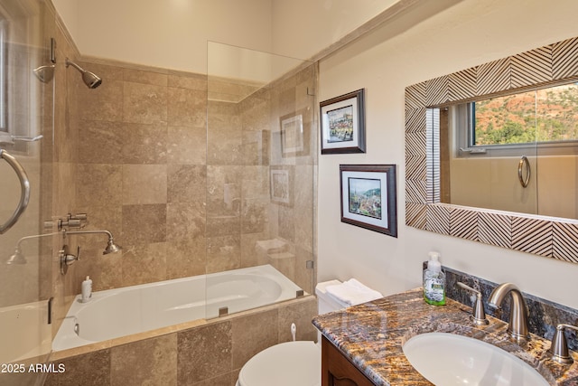 bathroom featuring tiled shower / bath combo, toilet, and vanity