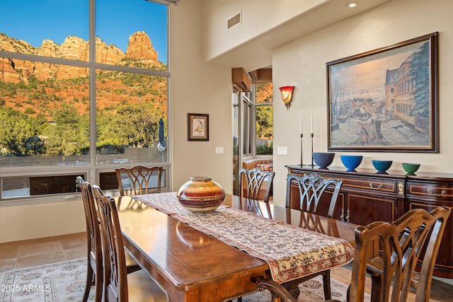 dining space with stone finish flooring and visible vents