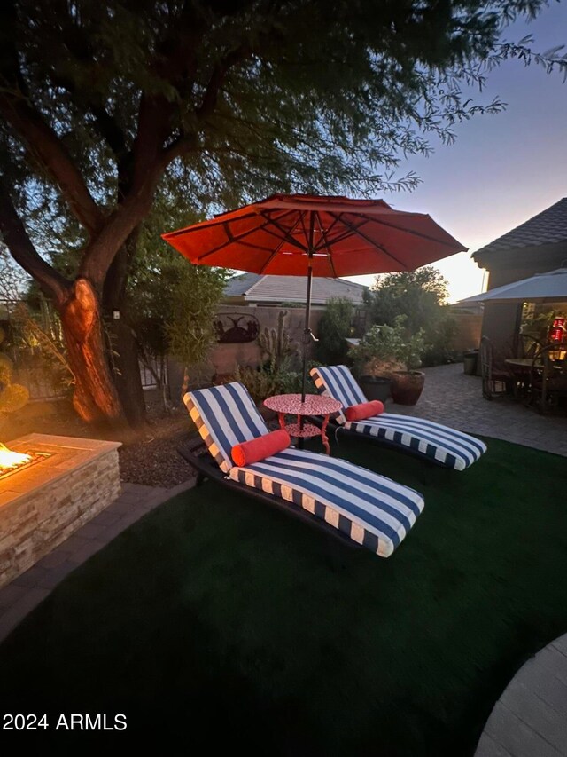 yard at dusk with a patio area