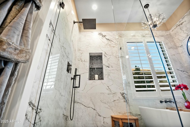 interior space featuring plus walk in shower, a chandelier, and sink