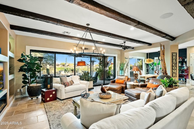 living room with beamed ceiling and ceiling fan with notable chandelier