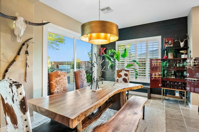 dining space featuring wooden walls