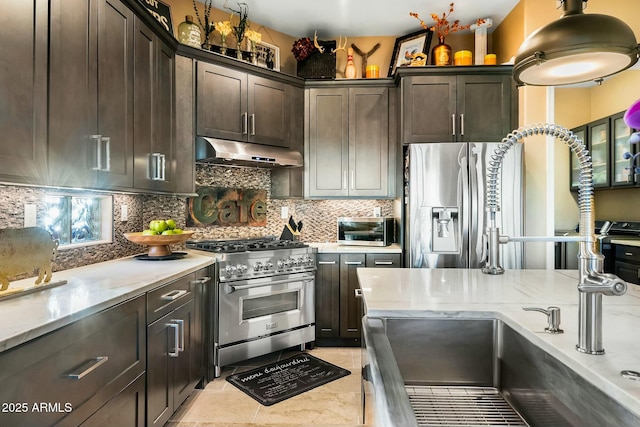 kitchen with backsplash, dark brown cabinetry, and stainless steel appliances