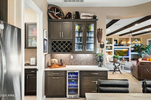 bar featuring decorative backsplash, stainless steel fridge, beverage cooler, pendant lighting, and beam ceiling