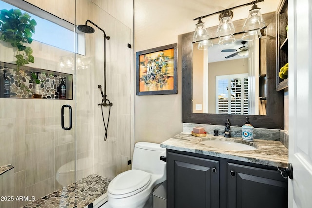 bathroom featuring walk in shower, a wealth of natural light, vanity, and toilet