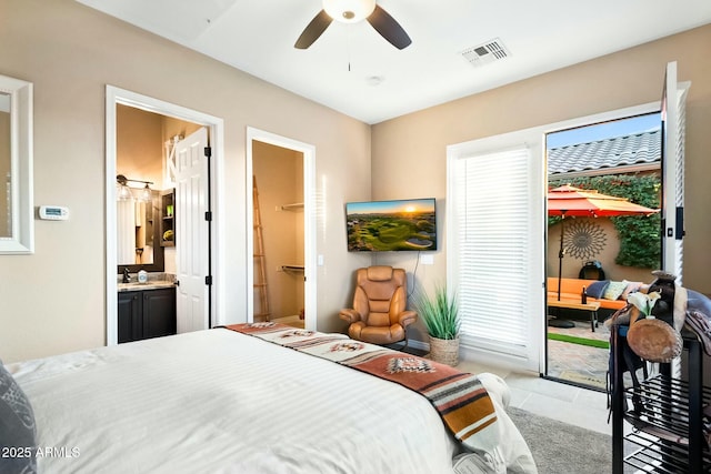 bedroom featuring ceiling fan, light tile patterned flooring, a spacious closet, and connected bathroom