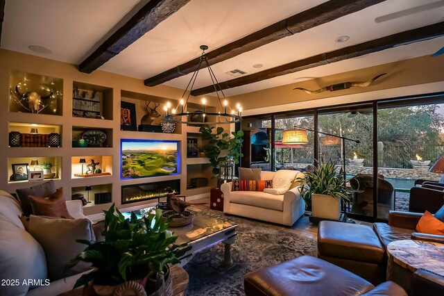 living room featuring beam ceiling and a chandelier