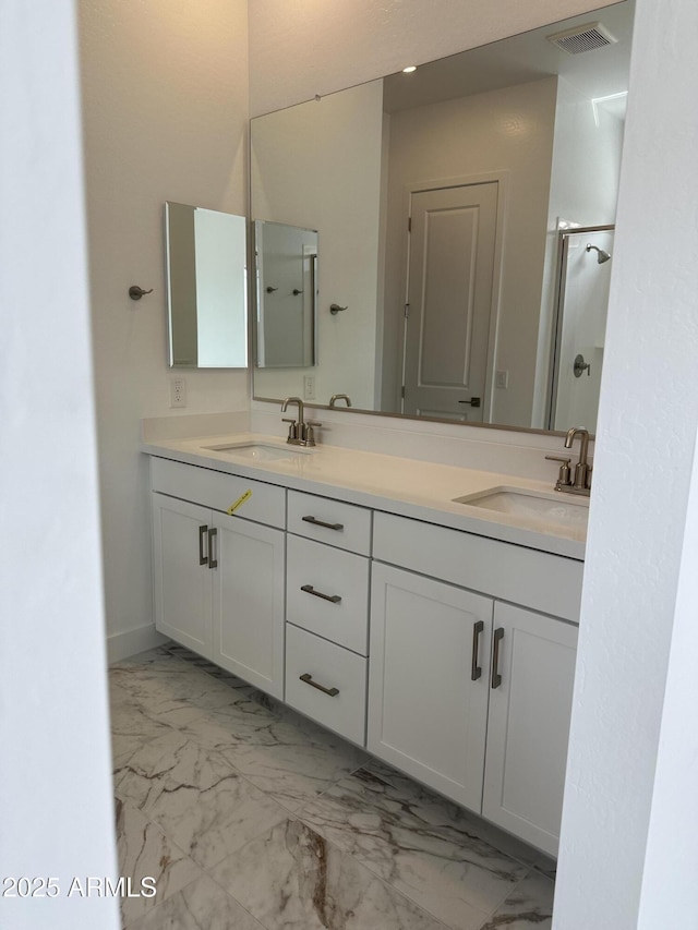 full bathroom featuring double vanity, visible vents, marble finish floor, and a sink