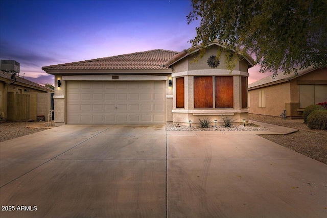 view of front facade featuring cooling unit and a garage