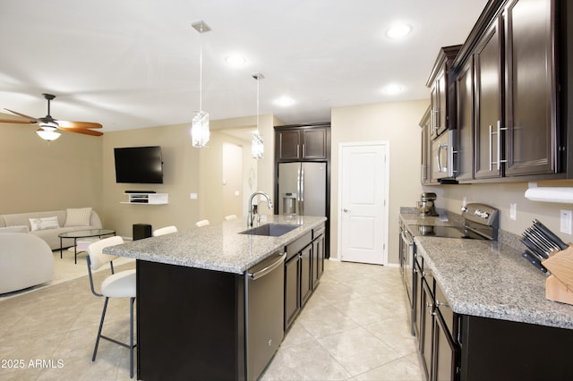 9295 W Wood Dr, Peoria, AZ 85381 - kitchen featuring a sink, a kitchen breakfast bar, open floor plan, appliances with stainless steel finishes, and ceiling fan
