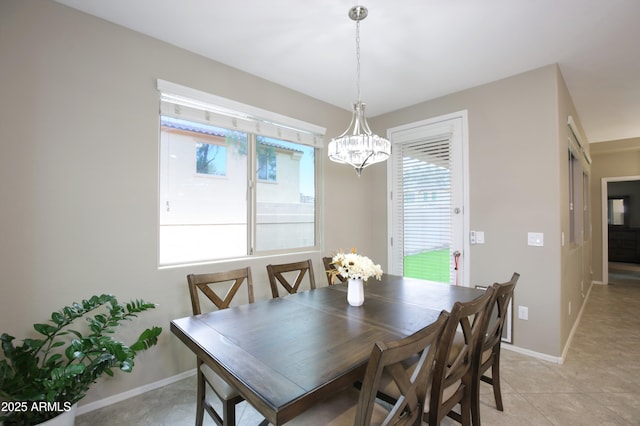 9295 W Wood Dr, Peoria, AZ 85381 - dining room with light tile patterned floors, baseboards, and an inviting chandelier
