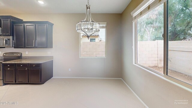 9295 W Wood Dr, Peoria, AZ 85381 - kitchen with decorative light fixtures, appliances with stainless steel finishes, baseboards, and an inviting chandelier