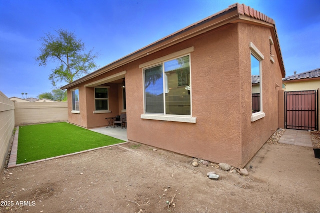 9295 W Wood Dr, Peoria, AZ 85381 - rear view of house with a patio area, a fenced backyard, and stucco siding