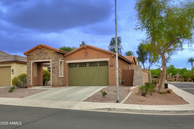 9295 W Wood Dr, Peoria, AZ 85381 - view of front of home with stucco siding, a gate, a tile roof, concrete driveway, and an attached garage