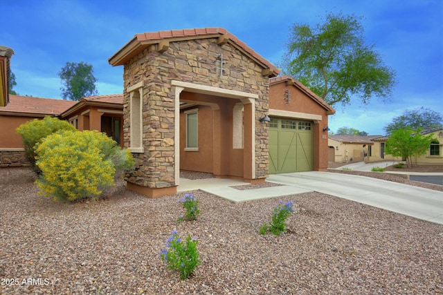 9295 W Wood Dr, Peoria, AZ 85381 - view of front of home with stucco siding, stone siding, concrete driveway, and an attached garage