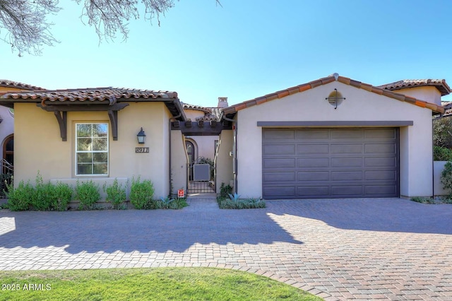 mediterranean / spanish house featuring a garage