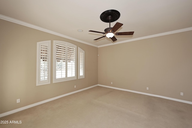 carpeted empty room with ceiling fan and ornamental molding