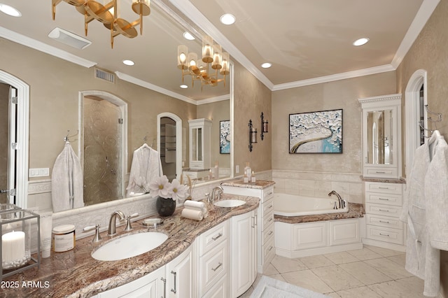 bathroom with tile patterned floors, vanity, a tub to relax in, a notable chandelier, and crown molding