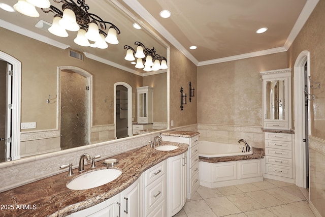 bathroom with vanity, a tub, crown molding, and tile patterned flooring