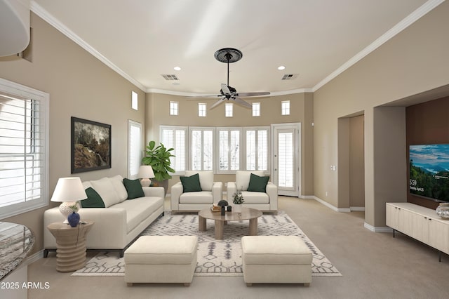 living room featuring light carpet, ceiling fan, and ornamental molding