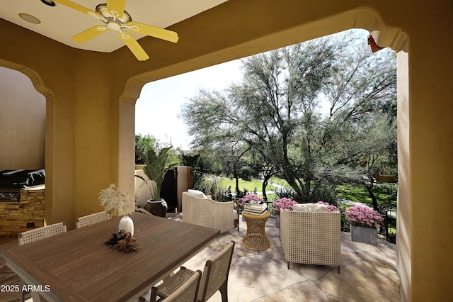 view of patio / terrace featuring ceiling fan and an outdoor kitchen