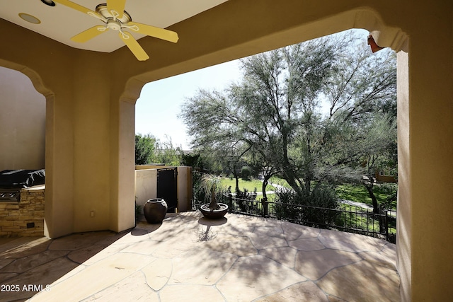 view of patio featuring ceiling fan and an outdoor kitchen