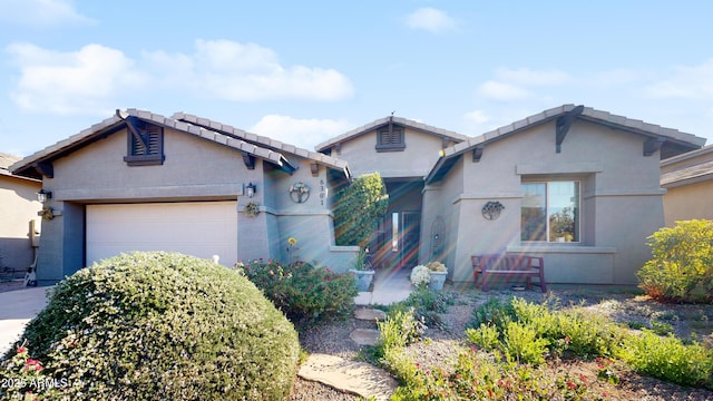 view of front of home with a garage and stucco siding