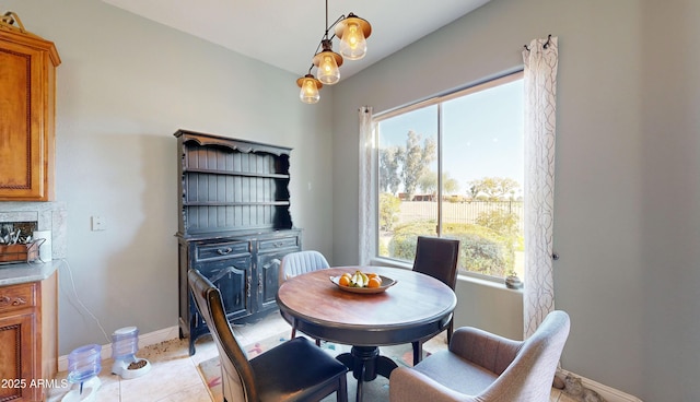 dining area featuring light tile patterned flooring and baseboards