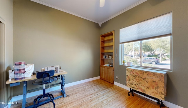 office space featuring light wood finished floors, baseboards, a ceiling fan, and ornamental molding