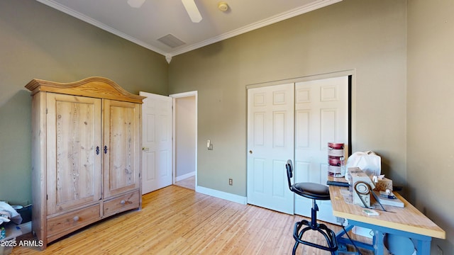 home office featuring light wood-type flooring, ceiling fan, baseboards, and crown molding