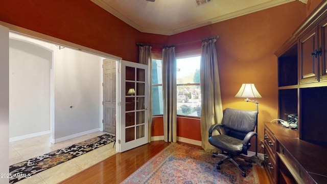 living area featuring tile patterned flooring, visible vents, crown molding, and baseboards