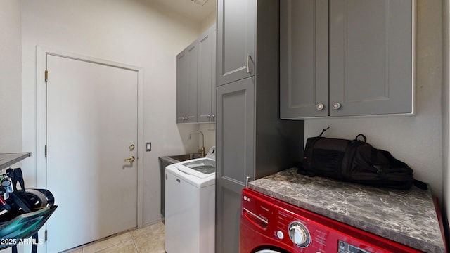 laundry area featuring cabinet space and light tile patterned floors