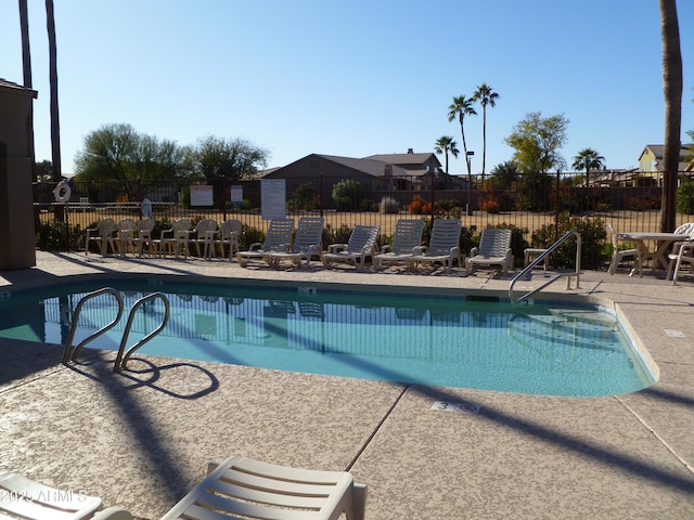 pool featuring a patio and fence