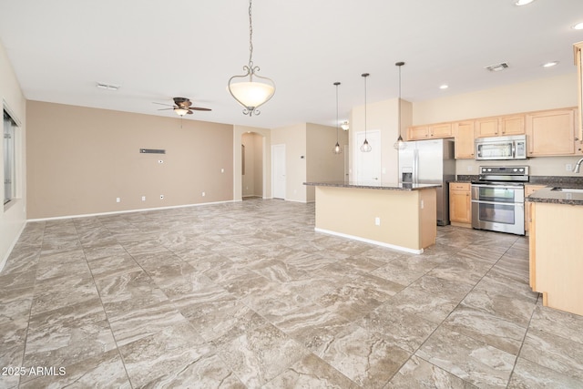 kitchen featuring visible vents, arched walkways, baseboards, appliances with stainless steel finishes, and light brown cabinets