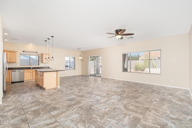 kitchen with stainless steel appliances, dark countertops, visible vents, open floor plan, and light brown cabinets