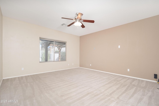 spare room with baseboards, visible vents, and light colored carpet