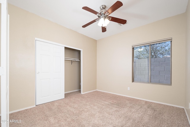 unfurnished bedroom featuring a ceiling fan, a closet, carpet flooring, and baseboards