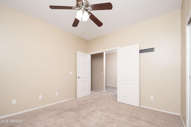 unfurnished bedroom featuring light colored carpet, ceiling fan, and baseboards