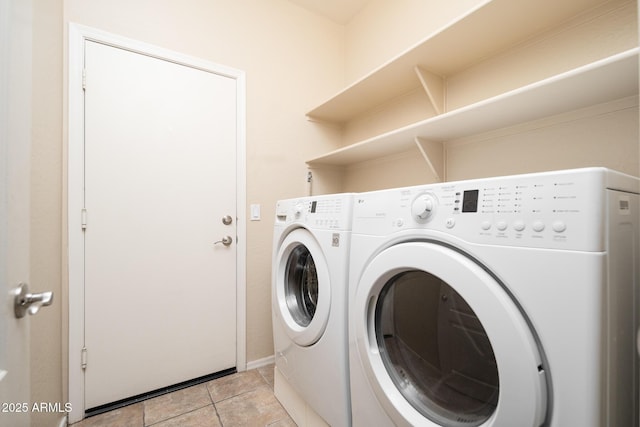 clothes washing area with laundry area, light tile patterned flooring, washing machine and dryer, and mail area