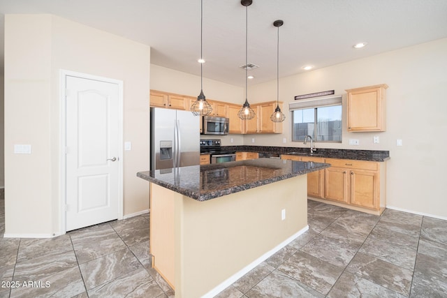 kitchen featuring light brown cabinets, stainless steel appliances, visible vents, a center island, and pendant lighting