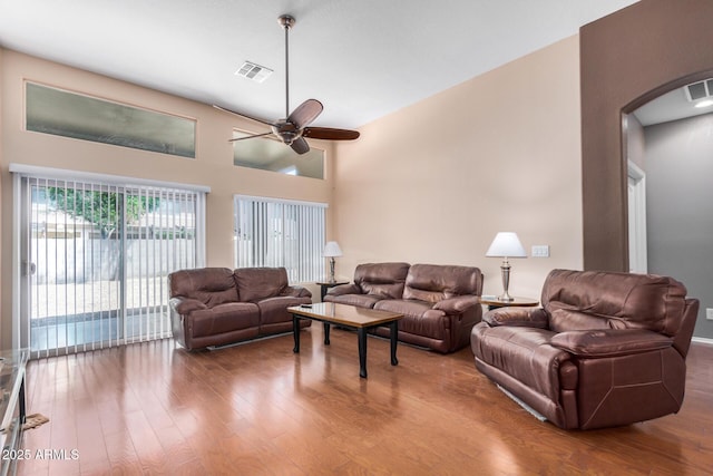 726 E Heather Dr, San Tan Valley, AZ 85140 - living room with a ceiling fan, arched walkways, and wood finished floors