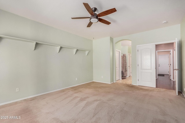 726 E Heather Dr, San Tan Valley, AZ 85140 - unfurnished bedroom featuring carpet floors, arched walkways, baseboards, ensuite bathroom, and a ceiling fan