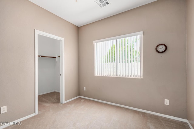 726 E Heather Dr, San Tan Valley, AZ 85140 - unfurnished bedroom featuring carpet, a walk in closet, baseboards, and a closet