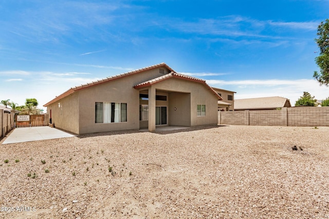 726 E Heather Dr, San Tan Valley, AZ 85140 - back of house featuring stucco siding, a patio, a fenced backyard, and a tile roof