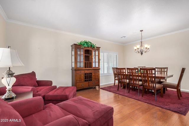 726 E Heather Dr, San Tan Valley, AZ 85140 - living area featuring wood finished floors, a chandelier, crown molding, and baseboards