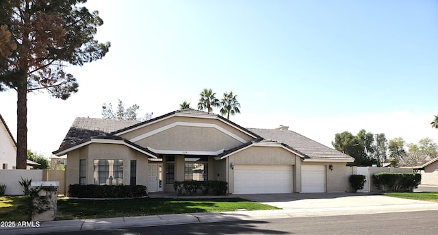 ranch-style house featuring concrete driveway, a tiled roof, an attached garage, fence, and stucco siding