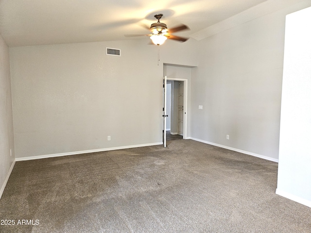 carpeted spare room with lofted ceiling, ceiling fan, visible vents, and baseboards