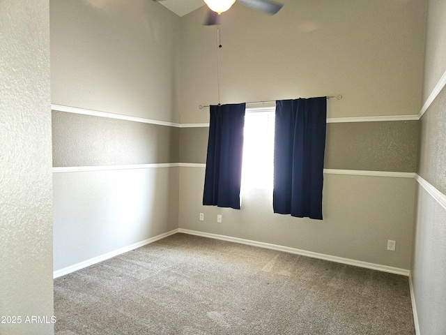 spare room with ceiling fan, carpet, and baseboards